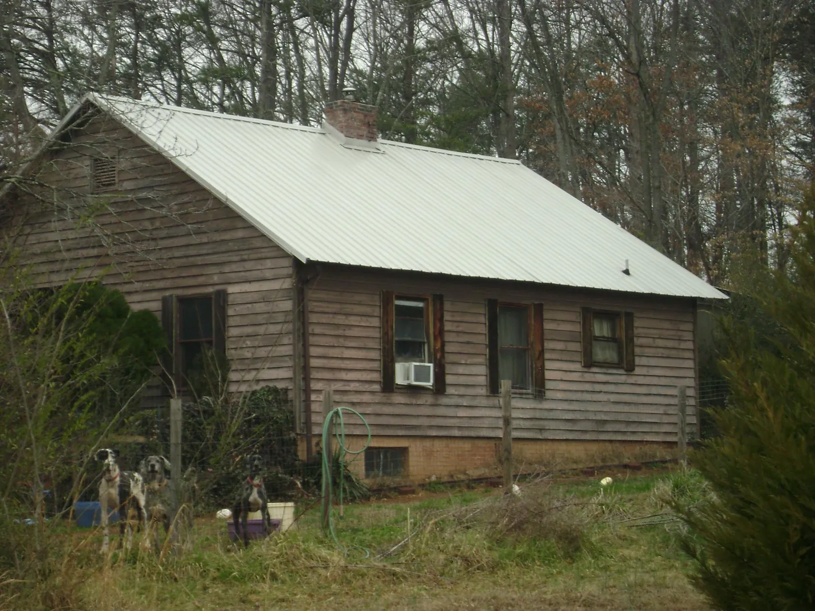 White metal roof on an old wood sided farmhouse, from a Metal Roof Installation job in Edgeley